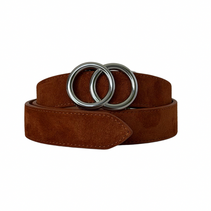 A brown suede belt with a large, polished silver-tone double-ring buckle, neatly coiled on a solid white background.